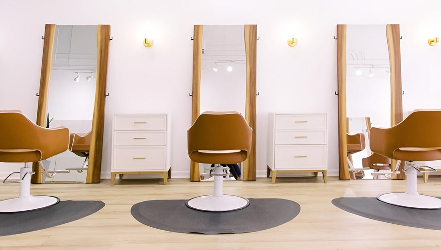 Modern salon chairs and mirrors at Fern & Ivy Hair Haus, Charlotte, North Carolina, US.