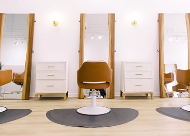 Modern salon chairs and mirrors at Fern & Ivy Hair Haus, Charlotte, North Carolina, US.
