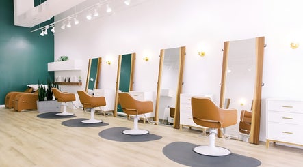 Modern salon chairs and mirrors at Fern & Ivy Hair Haus in Charlotte, North Carolina, US.