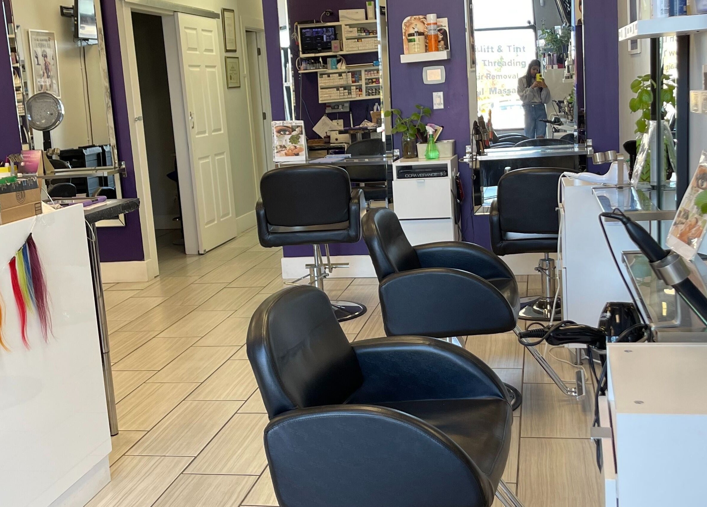 Modern interior of Si Salon and Spa in Edmonton, Alberta, CA with styling chairs and vibrant decor.