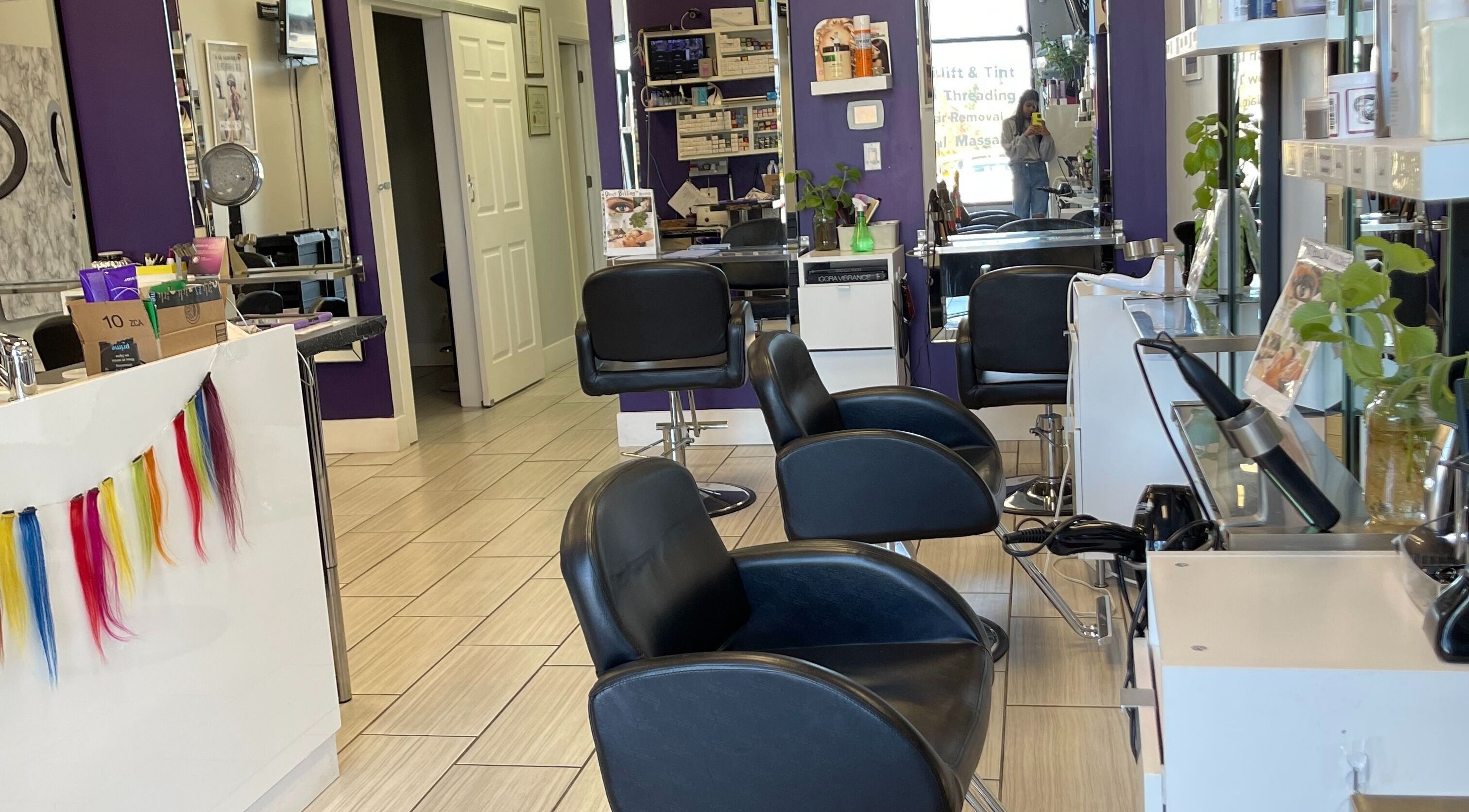 Modern interior of Si Salon and Spa in Edmonton, Alberta, CA with styling chairs and vibrant decor.