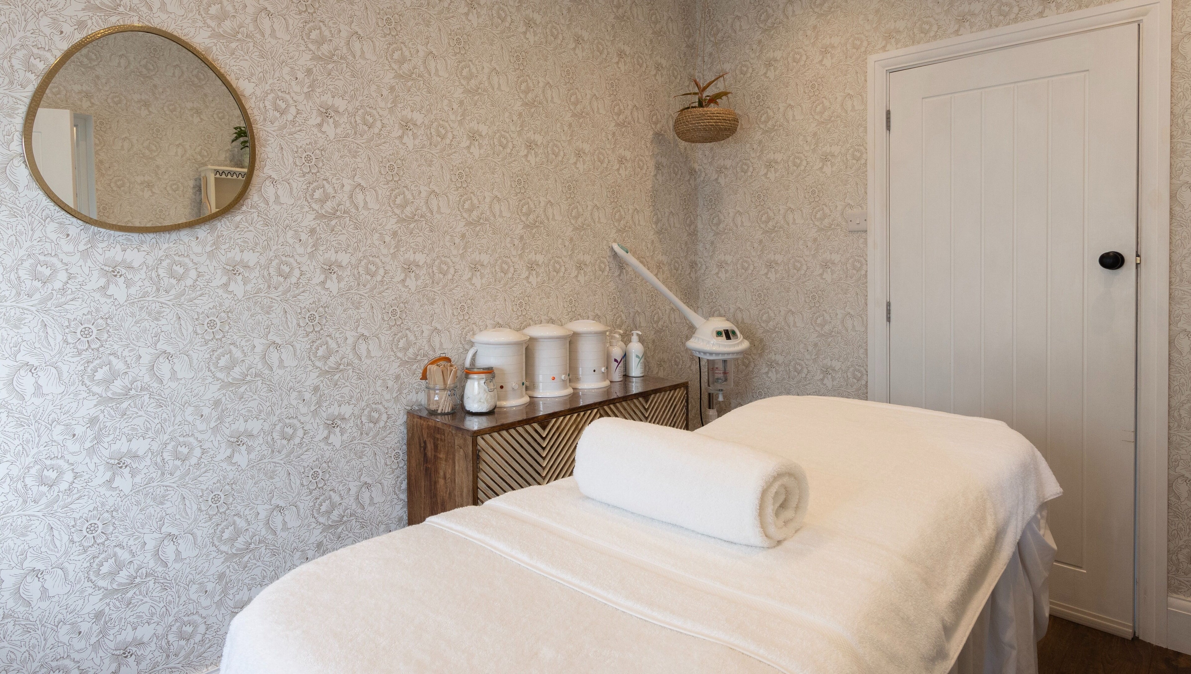 Massage room with warm decor at Cocoon Bristol, located in Bristol, England, GB offering a serene retreat.