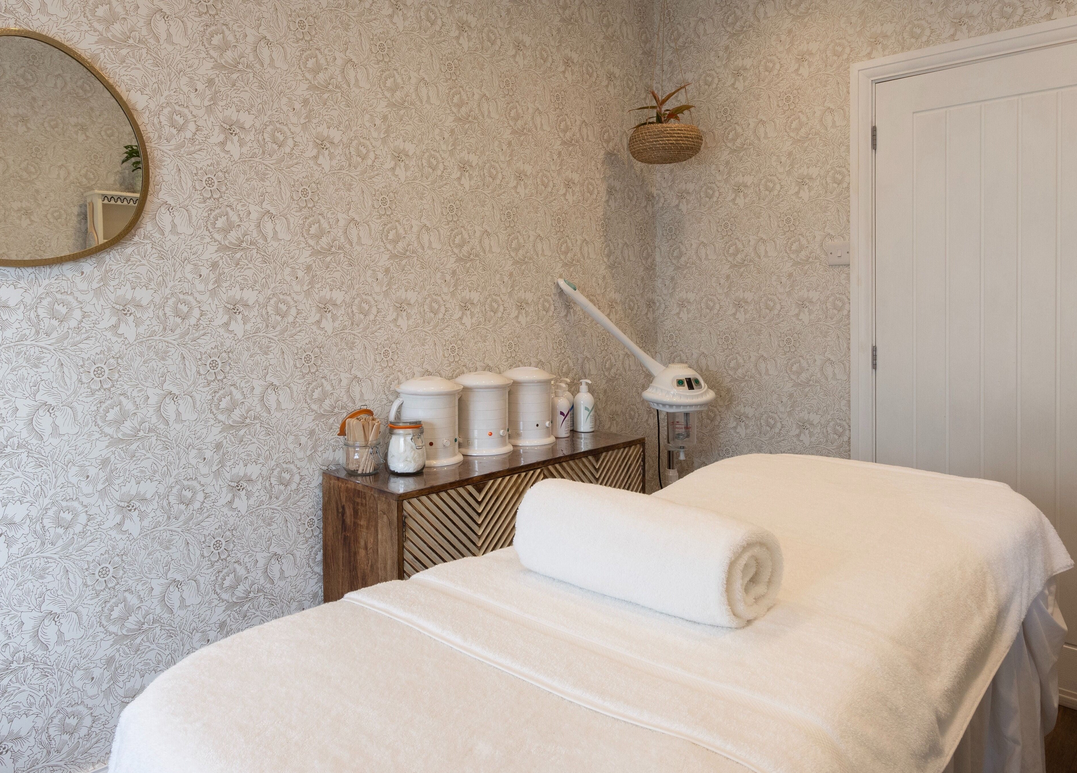 Massage room with warm decor at Cocoon Bristol, located in Bristol, England, GB offering a serene retreat.