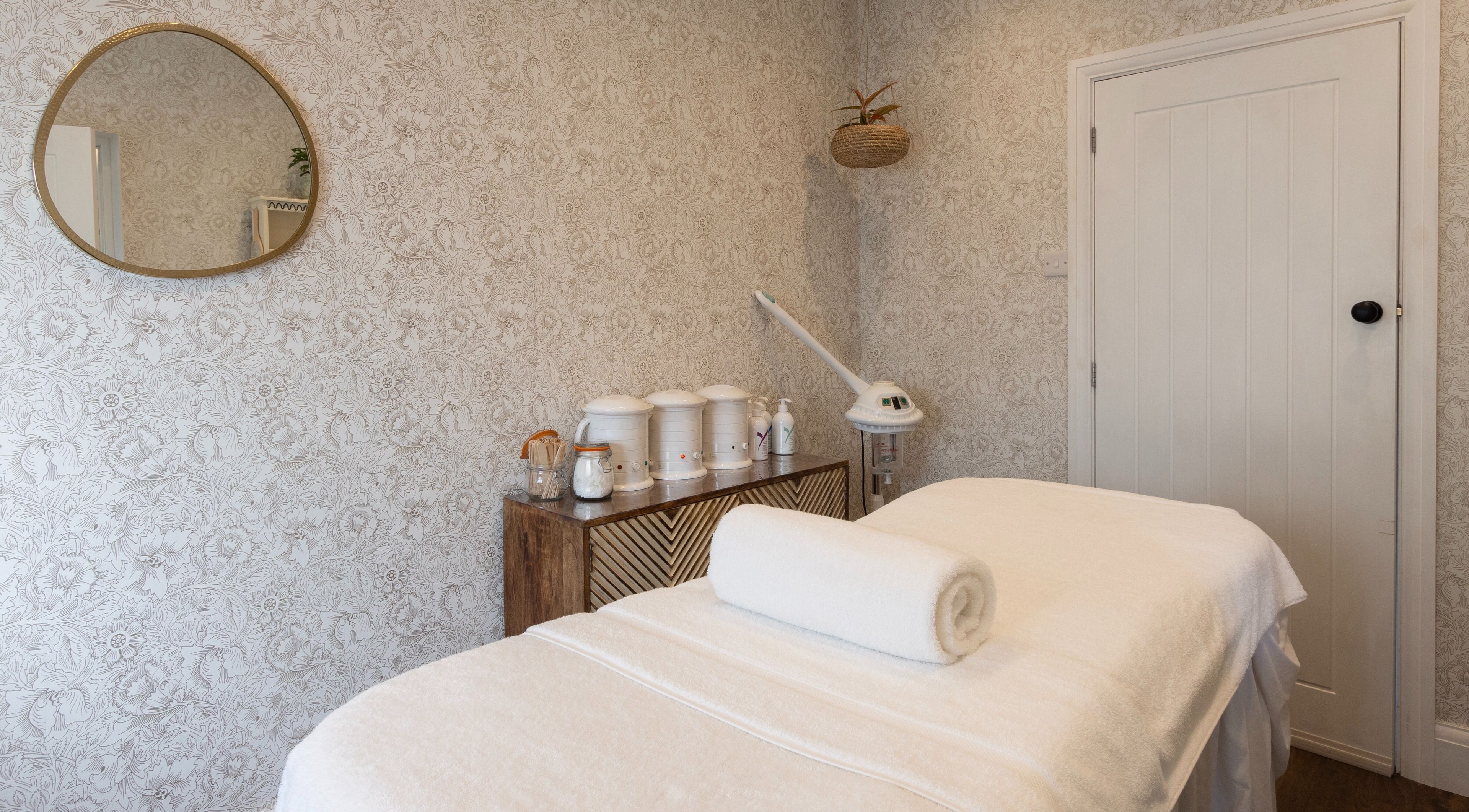 Massage room with warm decor at Cocoon Bristol, located in Bristol, England, GB offering a serene retreat.