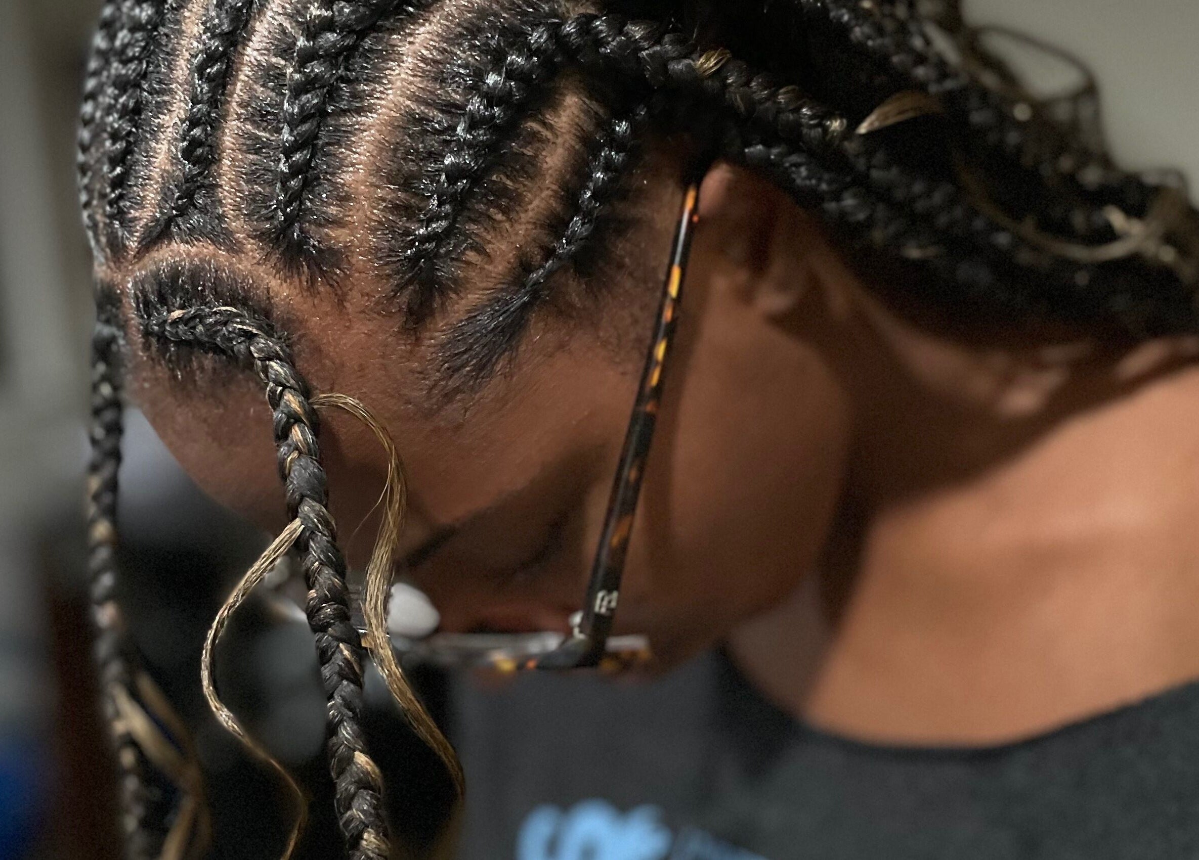 Intricate braids in progress at Loc’d N Loaded, Philadelphia, Pennsylvania, US, showcasing expert hairstyling.