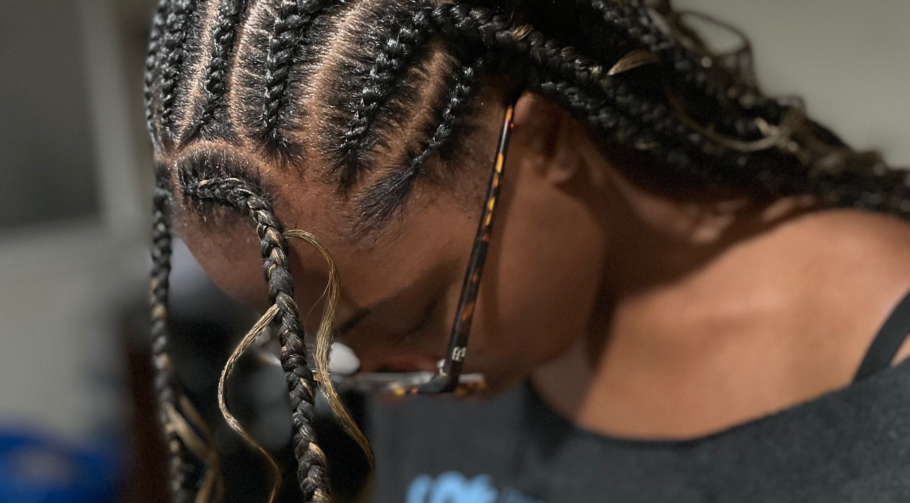 Intricate braids in progress at Loc’d N Loaded, Philadelphia, Pennsylvania, US, showcasing expert hairstyling.