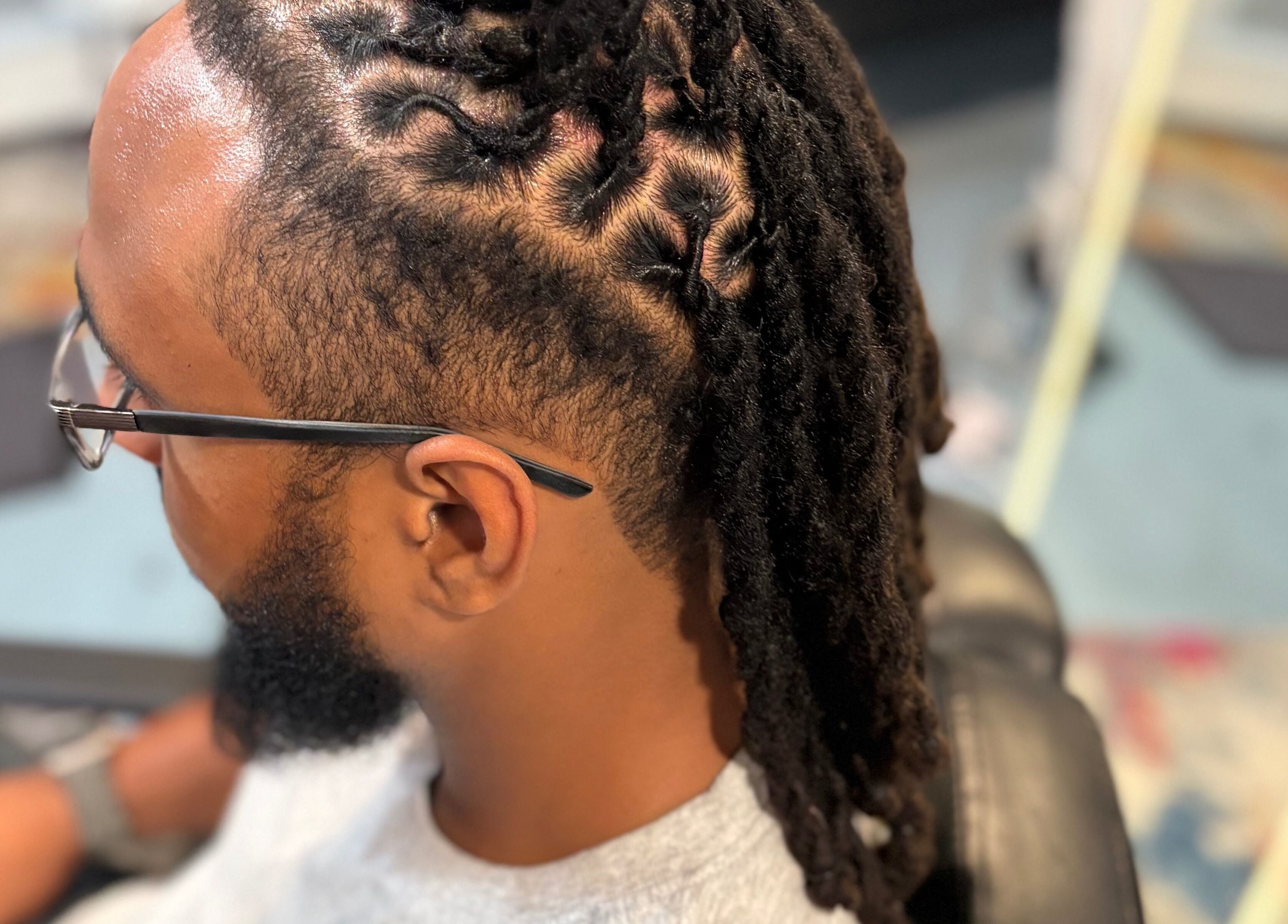 Close-up of styled locs at Loc’d N Loaded, Philadelphia, Pennsylvania, US, showcasing detailed craftsmanship.