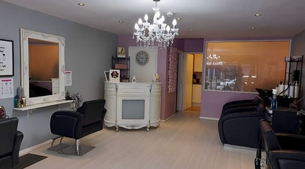 Interior view of The Hair Lounge, Halesowen, UK, showcasing chic decor and styling chairs.