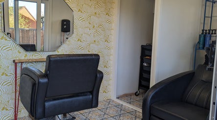 Cozy hairdressing chair at The Hair Lounge, Halesowen, United Kingdom, GB with stylish wallpaper and decor.