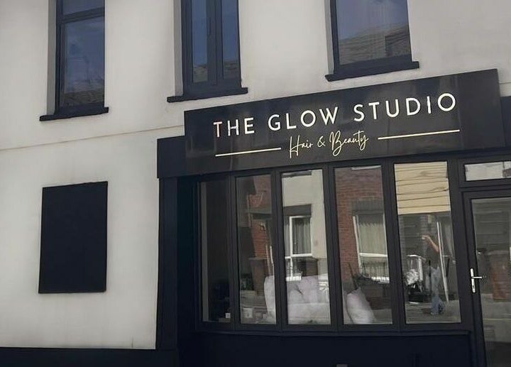 The Glow Studio Beauty Salon's stylish exterior in Neath, Wales, GB, showcasing a modern black facade.