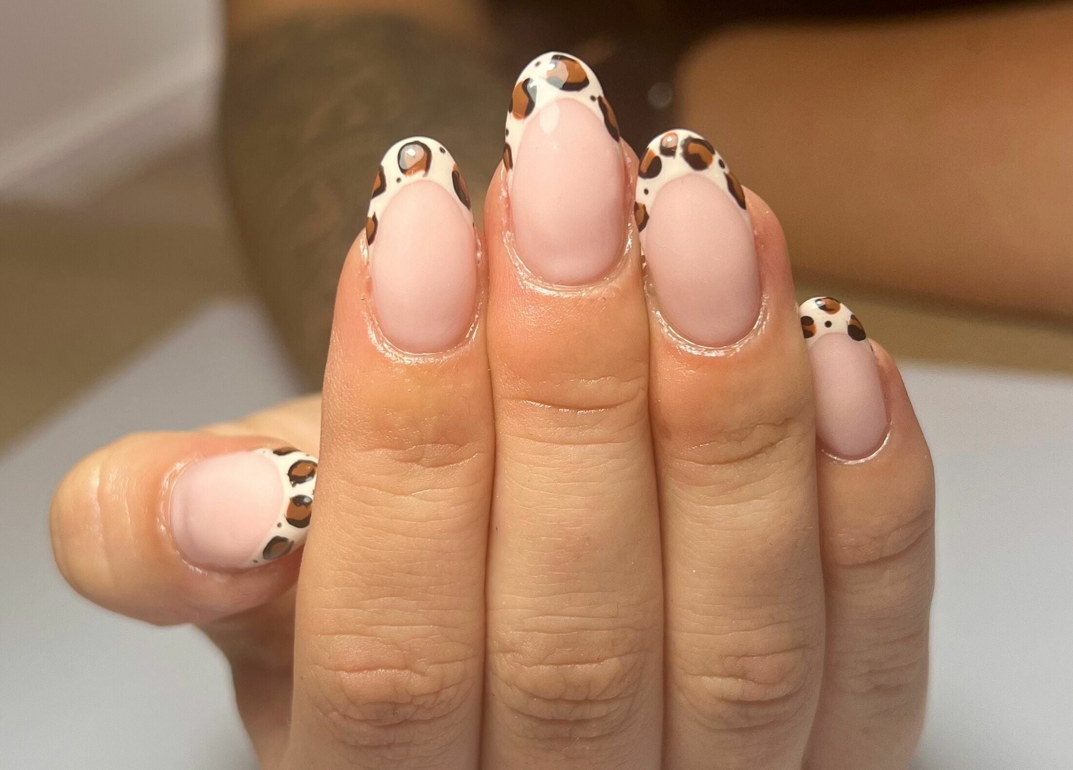 Stylish leopard print nails at The Glow Studio Beauty Salon in Neath, Wales, GB, showcasing expert nail design.