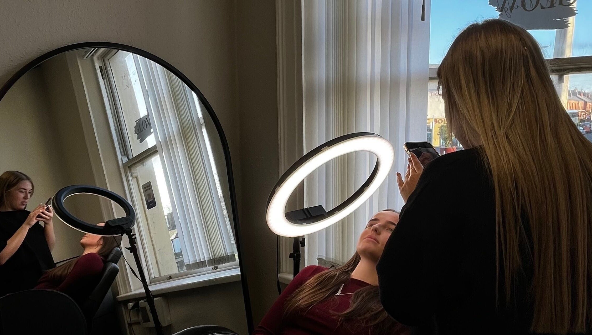 Brow Envy artist enhancing client beauty with ring light in Dublin, County Dublin, IE.