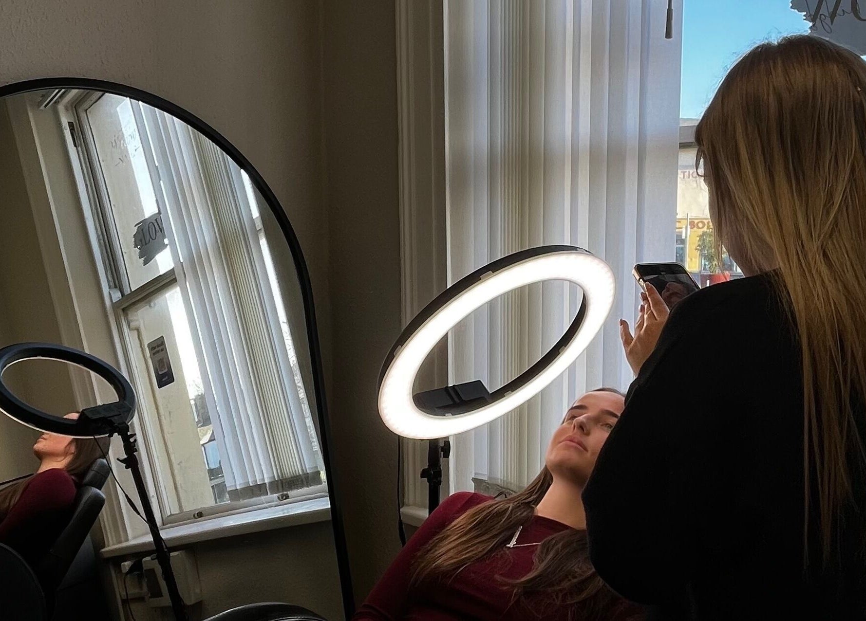 Brow Envy artist enhancing client beauty with ring light in Dublin, County Dublin, IE.