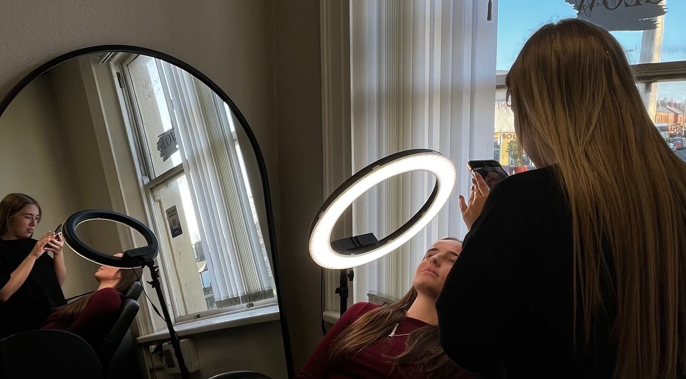Brow Envy artist enhancing client beauty with ring light in Dublin, County Dublin, IE.