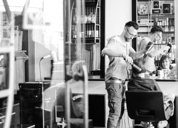 Stylist working at Get Marked by Mark salon in Cape Town, Western Cape, ZA, styling a client's hair.