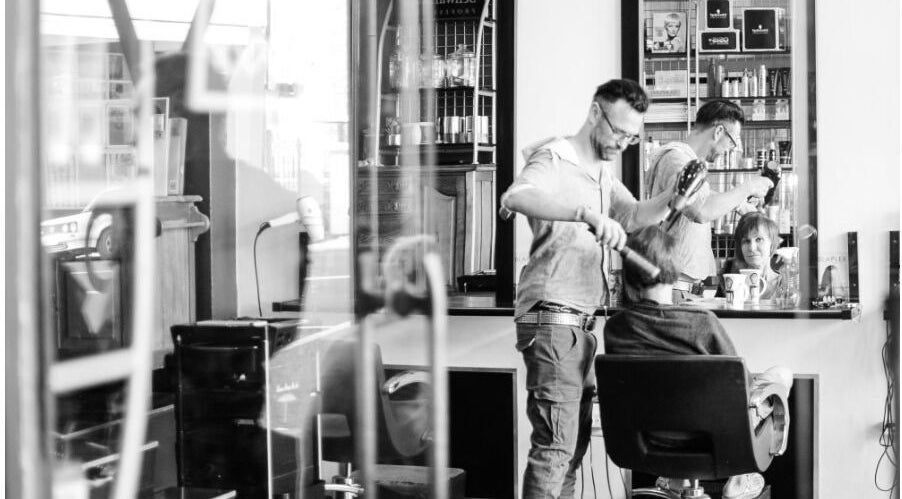 Stylist working at Get Marked by Mark salon in Cape Town, Western Cape, ZA, styling a client's hair.