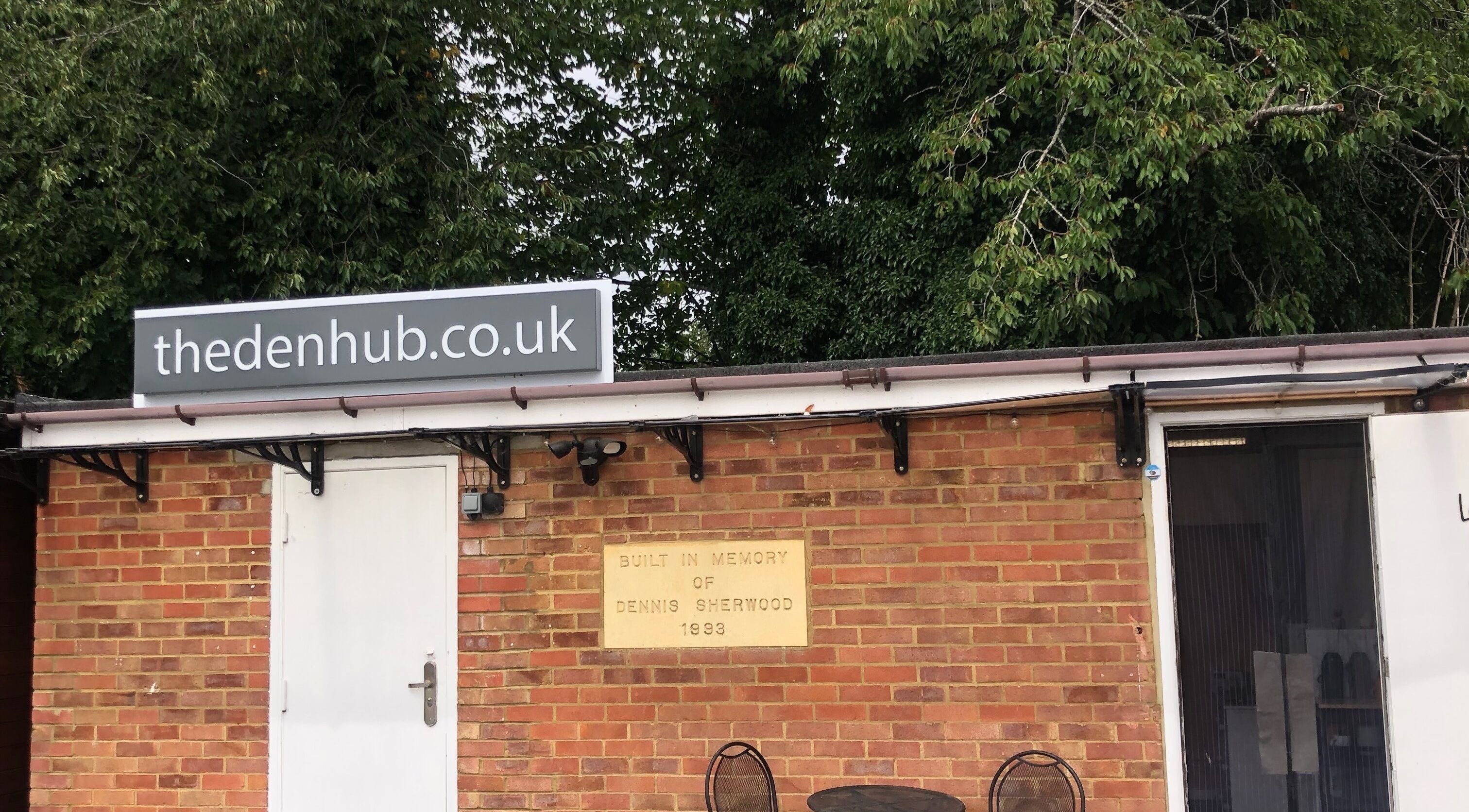 The Beauty Den entrance in Baldock, England, GB with a charming brick facade and greenery.