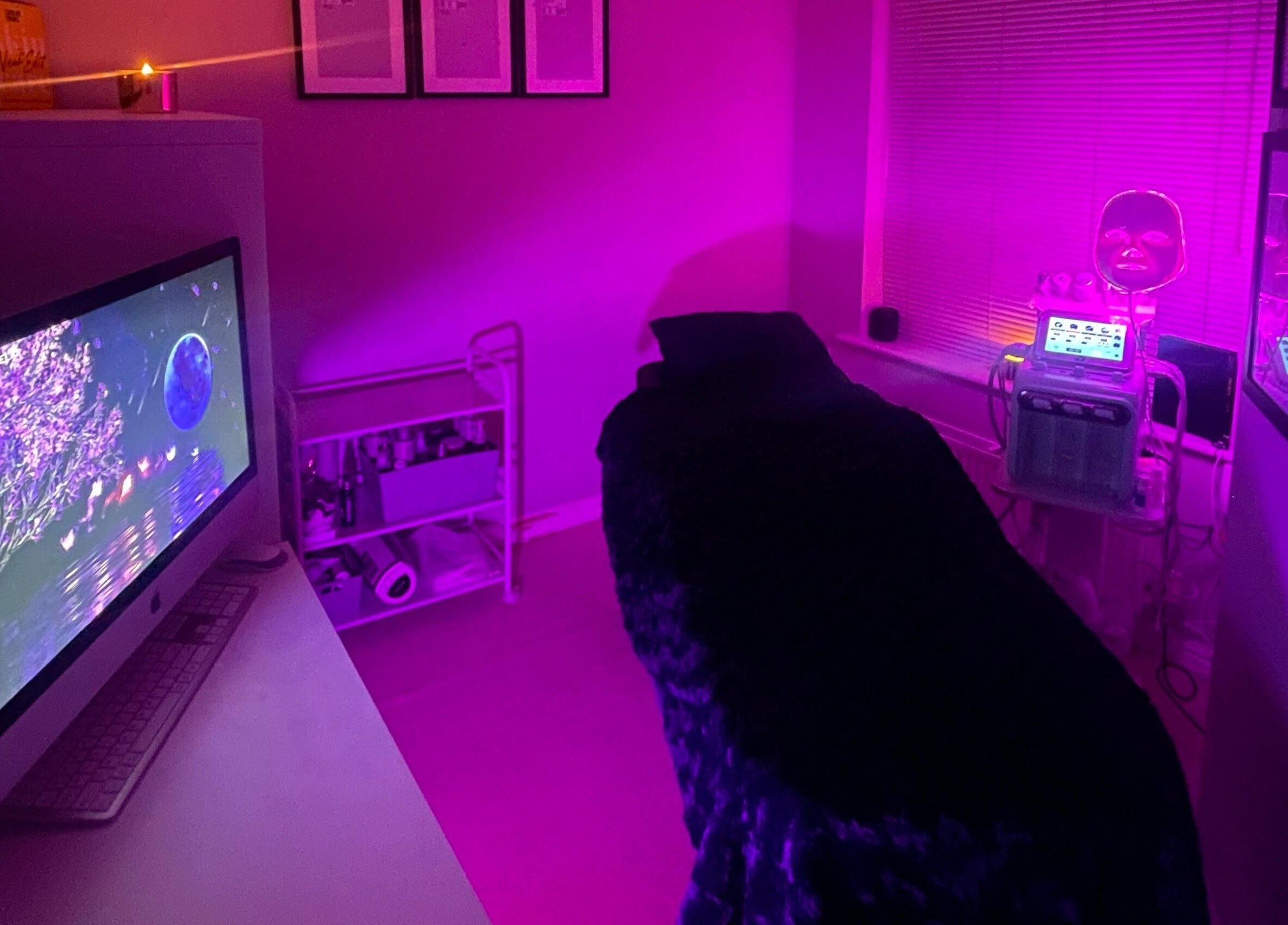 Relaxing spa room at Skinfinity+ Wokingham, England, GB, with dim pink lighting and modern LED therapy machines.