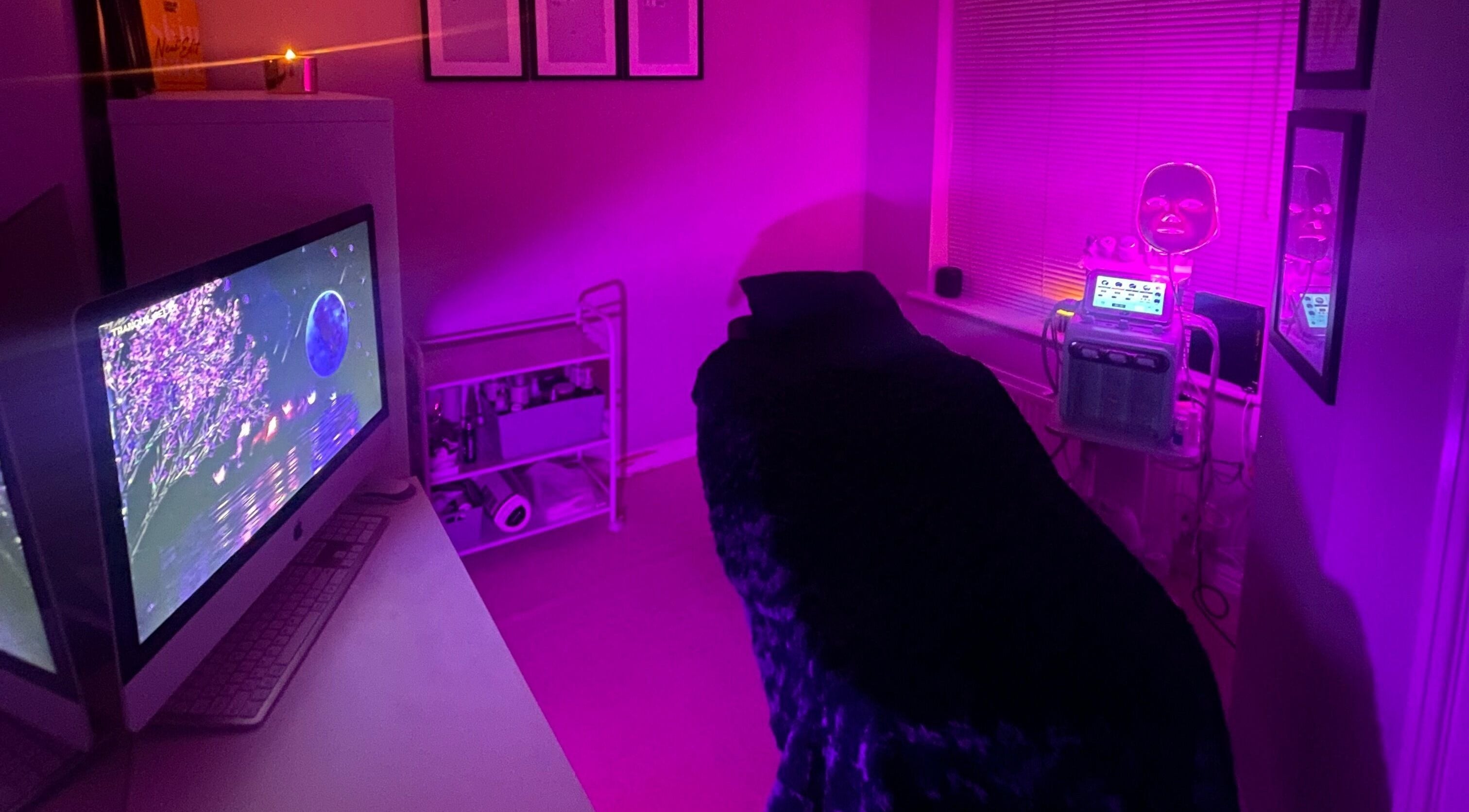 Relaxing spa room at Skinfinity+ Wokingham, England, GB, with dim pink lighting and modern LED therapy machines.