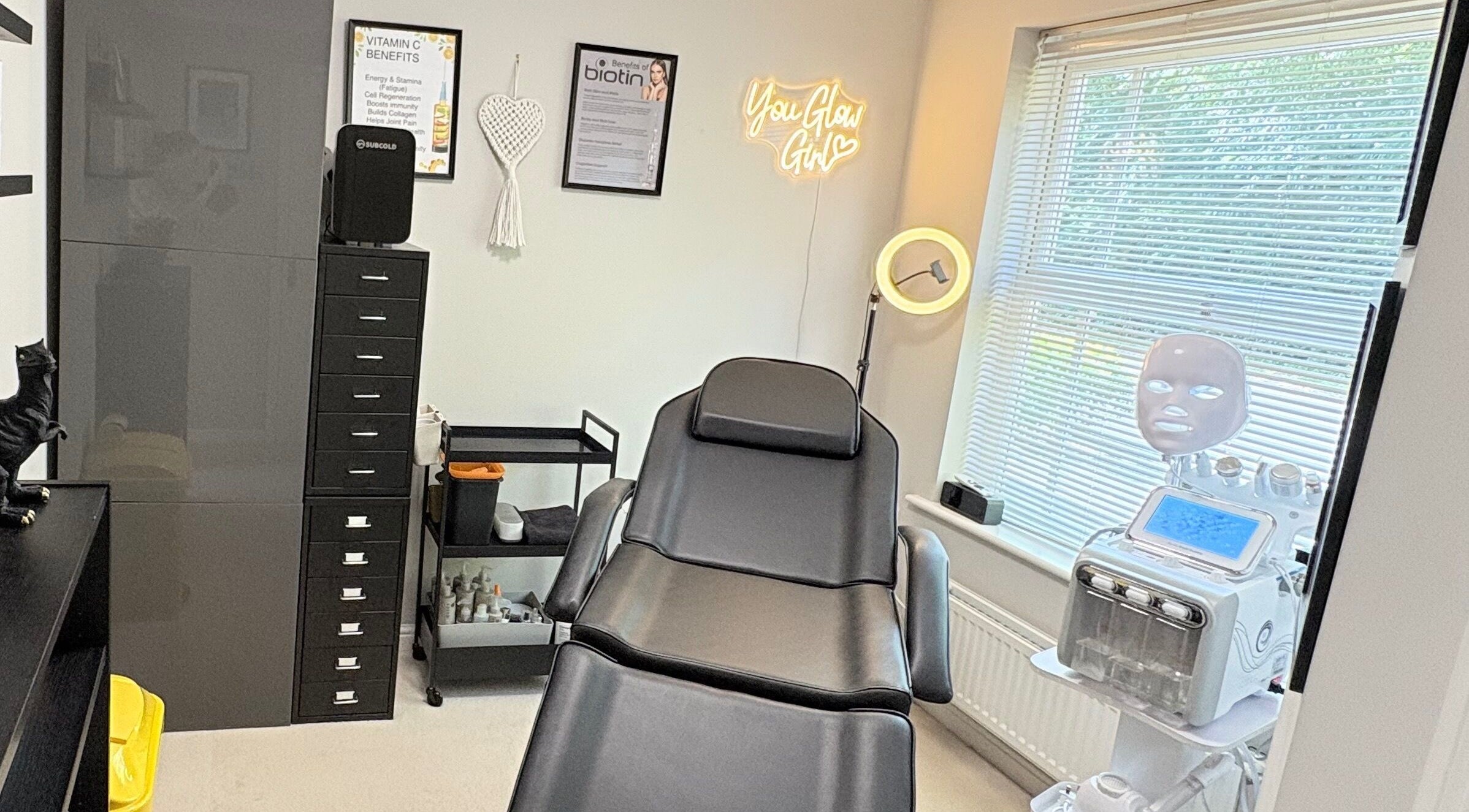 Skinfinity+ luxurious treatment room in Wokingham, England, GB, featuring a modern therapy chair and neon sign.