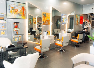 Modern interior of Perception London - Hair & Nail Salon, London, England, GB, featuring stylish salon chairs.