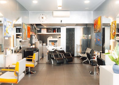 Modern interior of Perception London - Hair & Nail Salon, London, England, GB with stylish chairs and art.