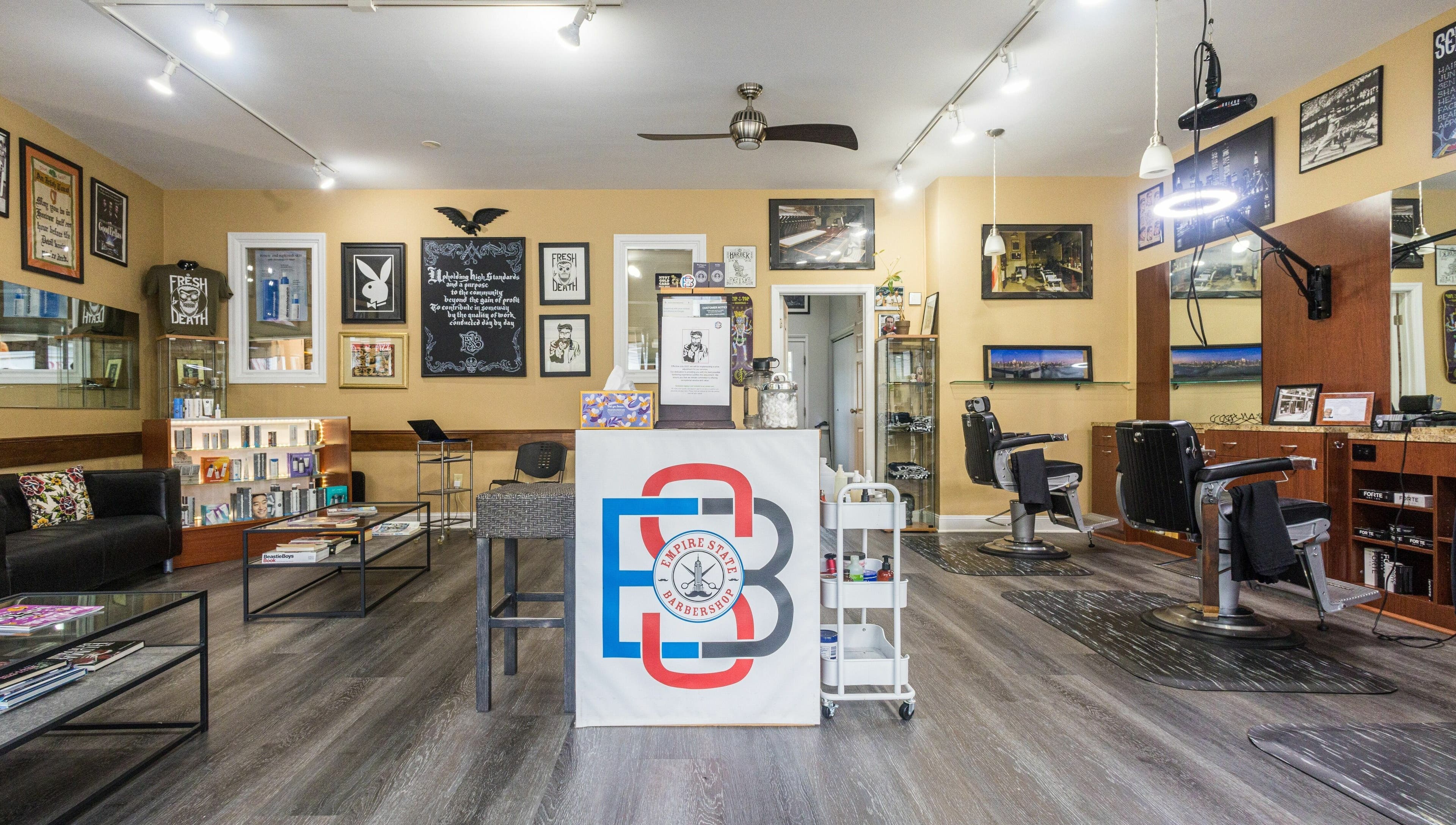 Modern interior of Empire State Barbershop in Tappan, New York, US with stylish decor and barber chairs.