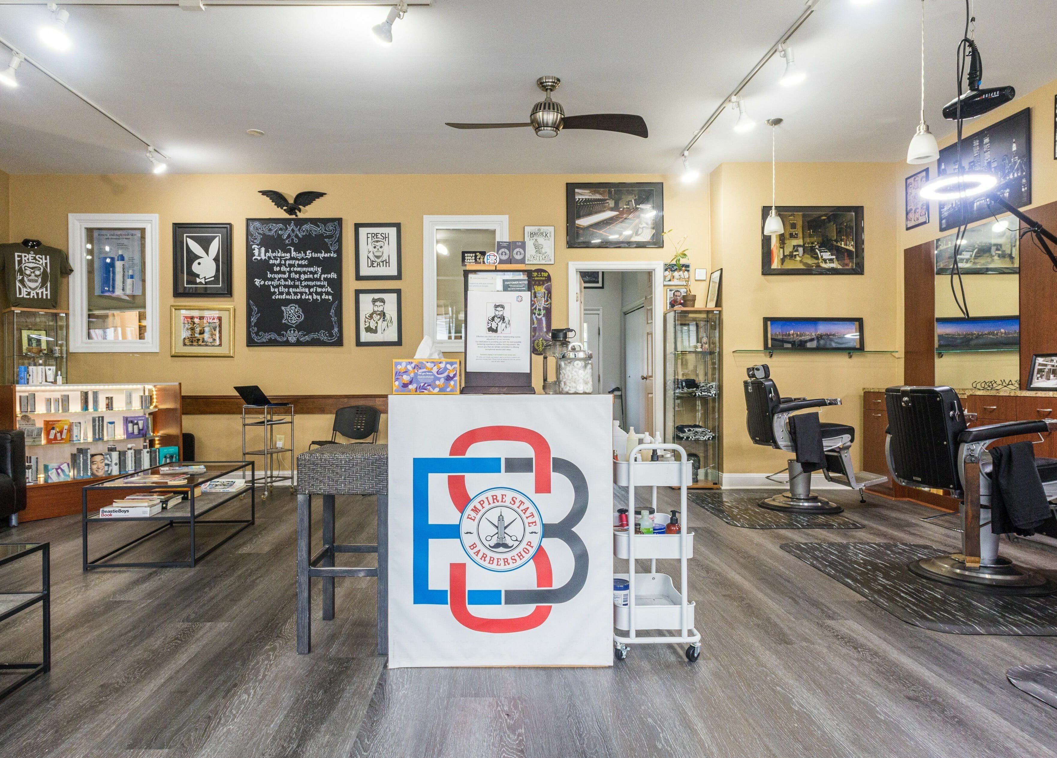 Modern interior of Empire State Barbershop in Tappan, New York, US with stylish decor and barber chairs.