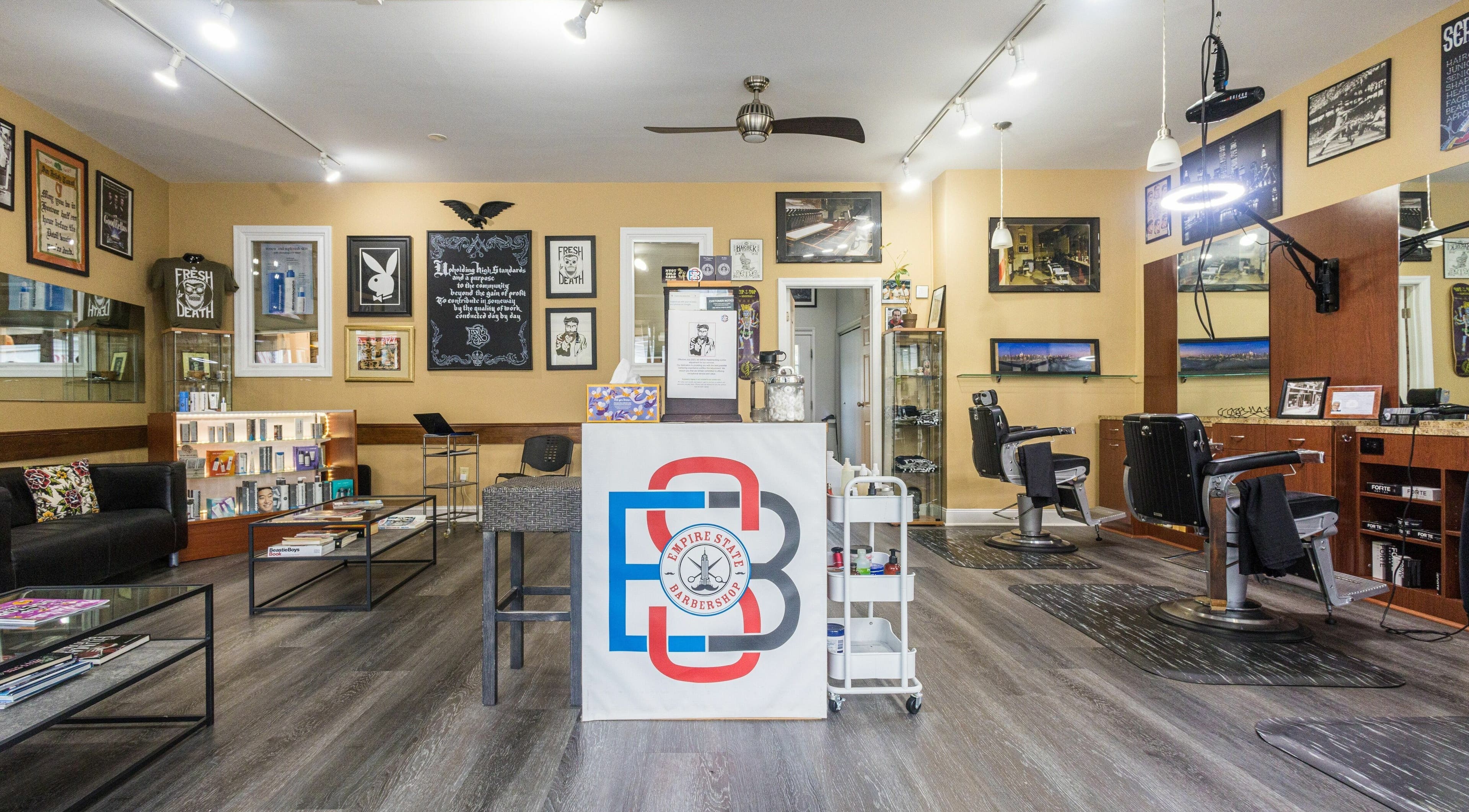 Modern interior of Empire State Barbershop in Tappan, New York, US with stylish decor and barber chairs.