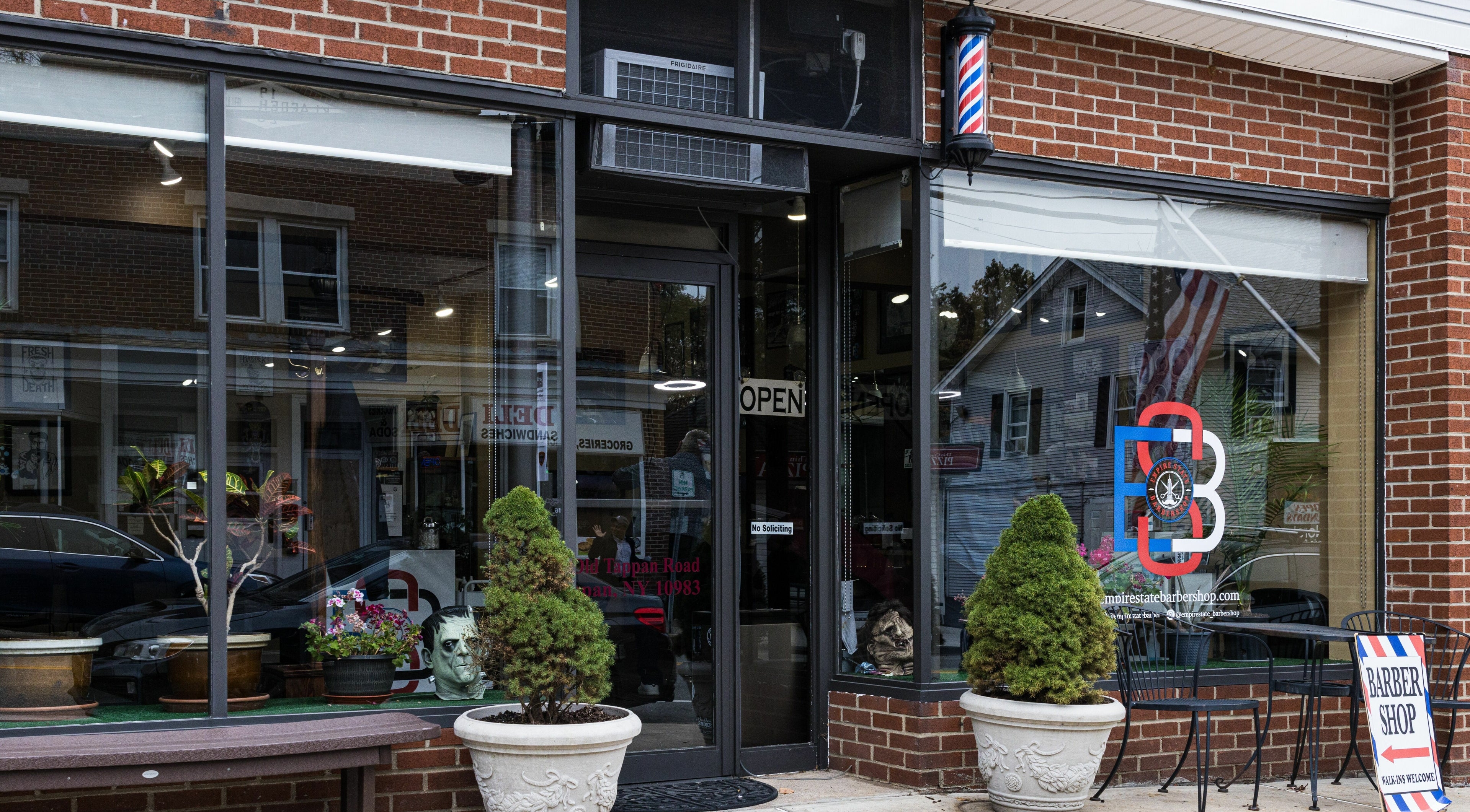 Exterior view of Empire State Barbershop, located in Tappan, New York, US. Inviting entrance with modern signage.