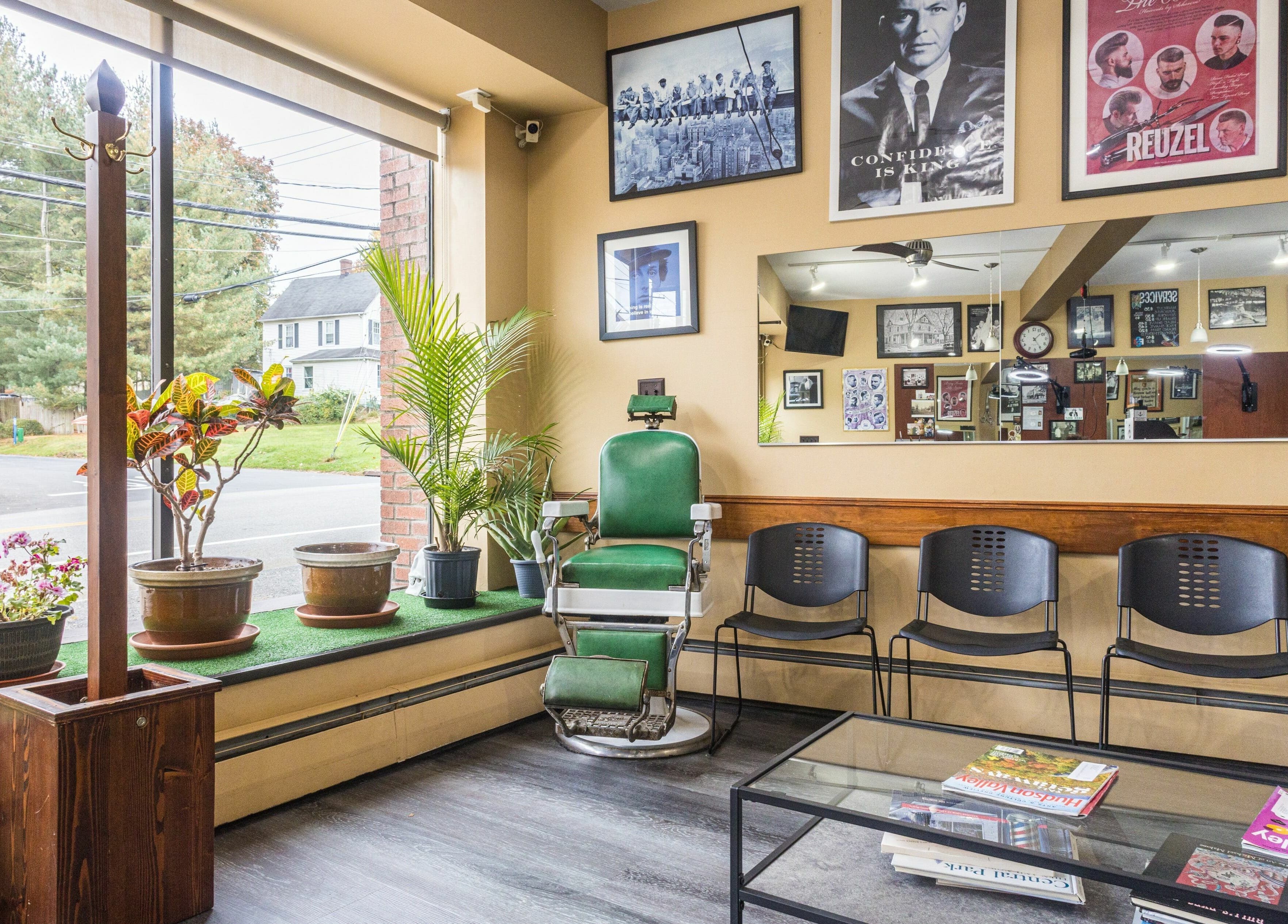 Empire State Barbershop in Tappan, New York, US, features vintage chairs and vibrant decor in a cozy waiting area.