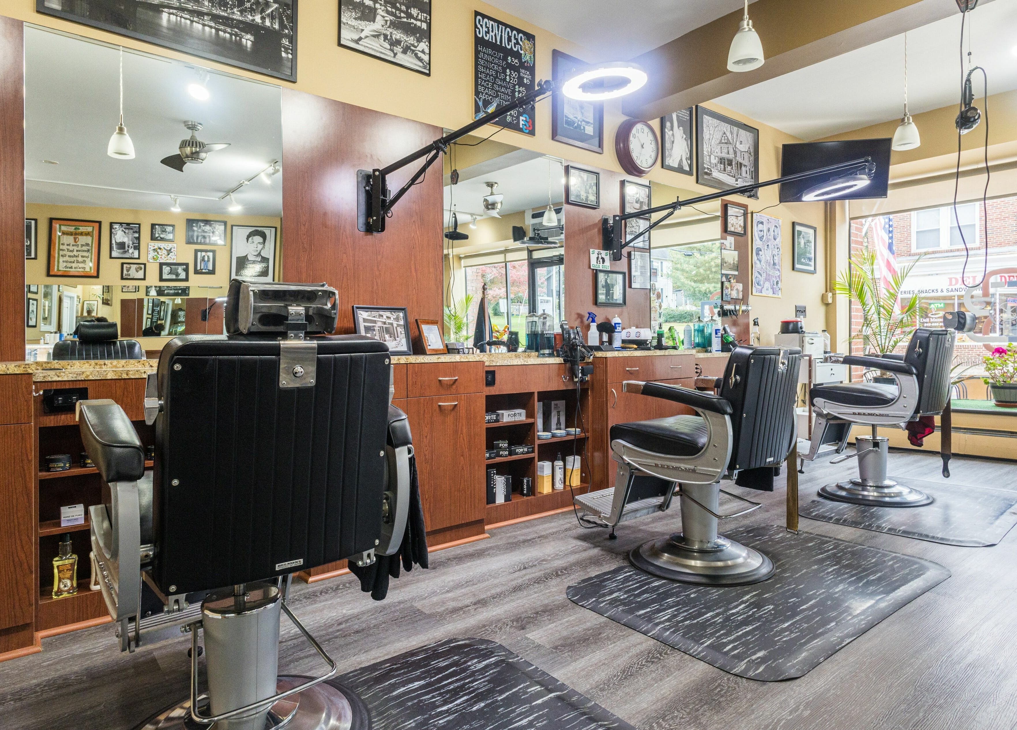Cozy interior of Empire State Barbershop in Tappan, New York, US, showcasing styling chairs and decor.