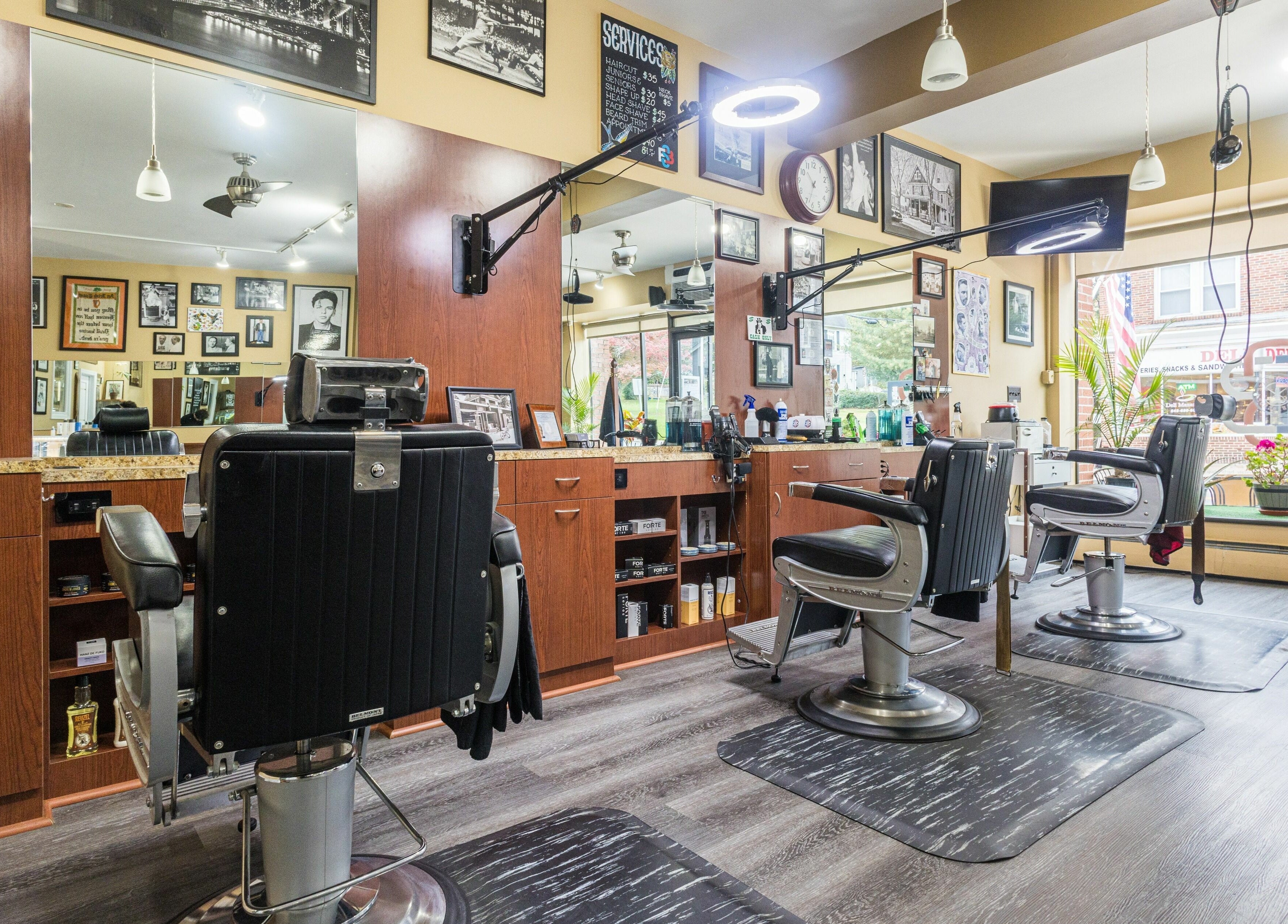 Cozy interior of Empire State Barbershop in Tappan, New York, US, showcasing styling chairs and decor.