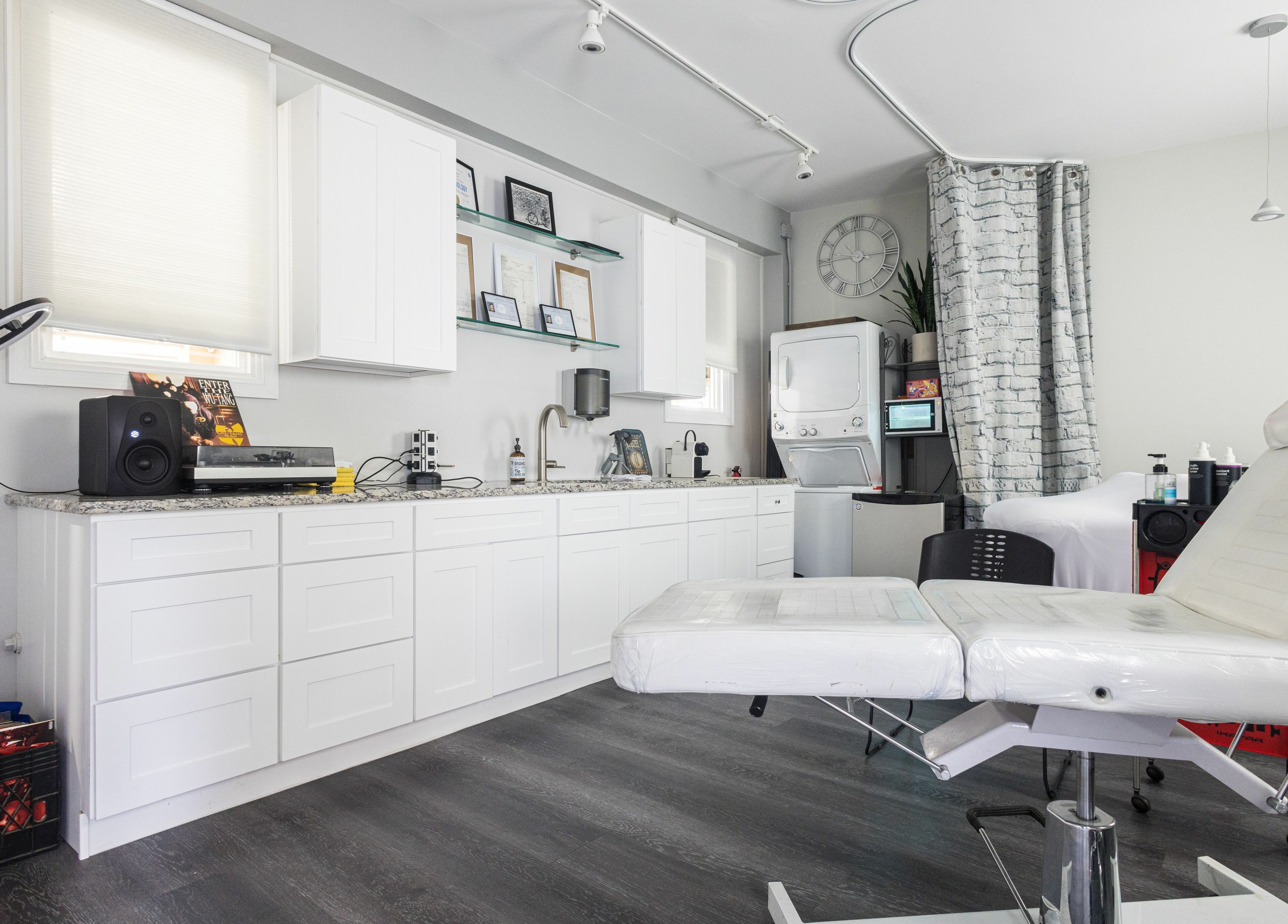 Modern interior of Empire State Barbershop in Tappan, New York, US featuring stylish treatment area.