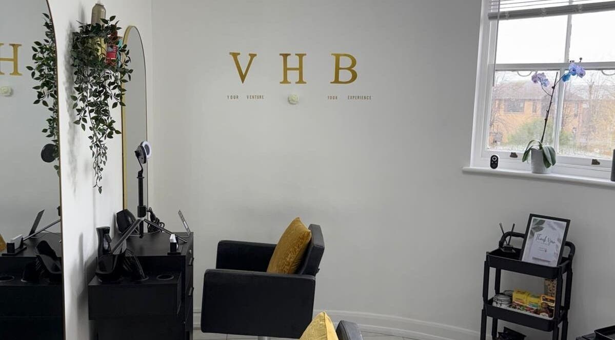 Modern salon interior at Venture Hair & Beauty, Chelmsford, England, GB, with stylish mirror and chair.