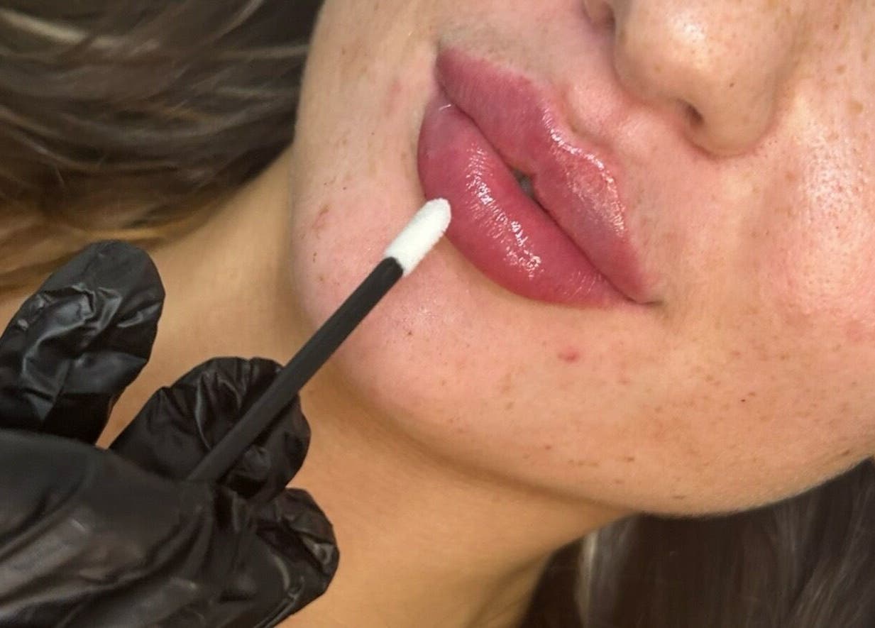 Professional lip gloss application at The Beauty Clinic in Bedford, England, GB, enhancing natural beauty.