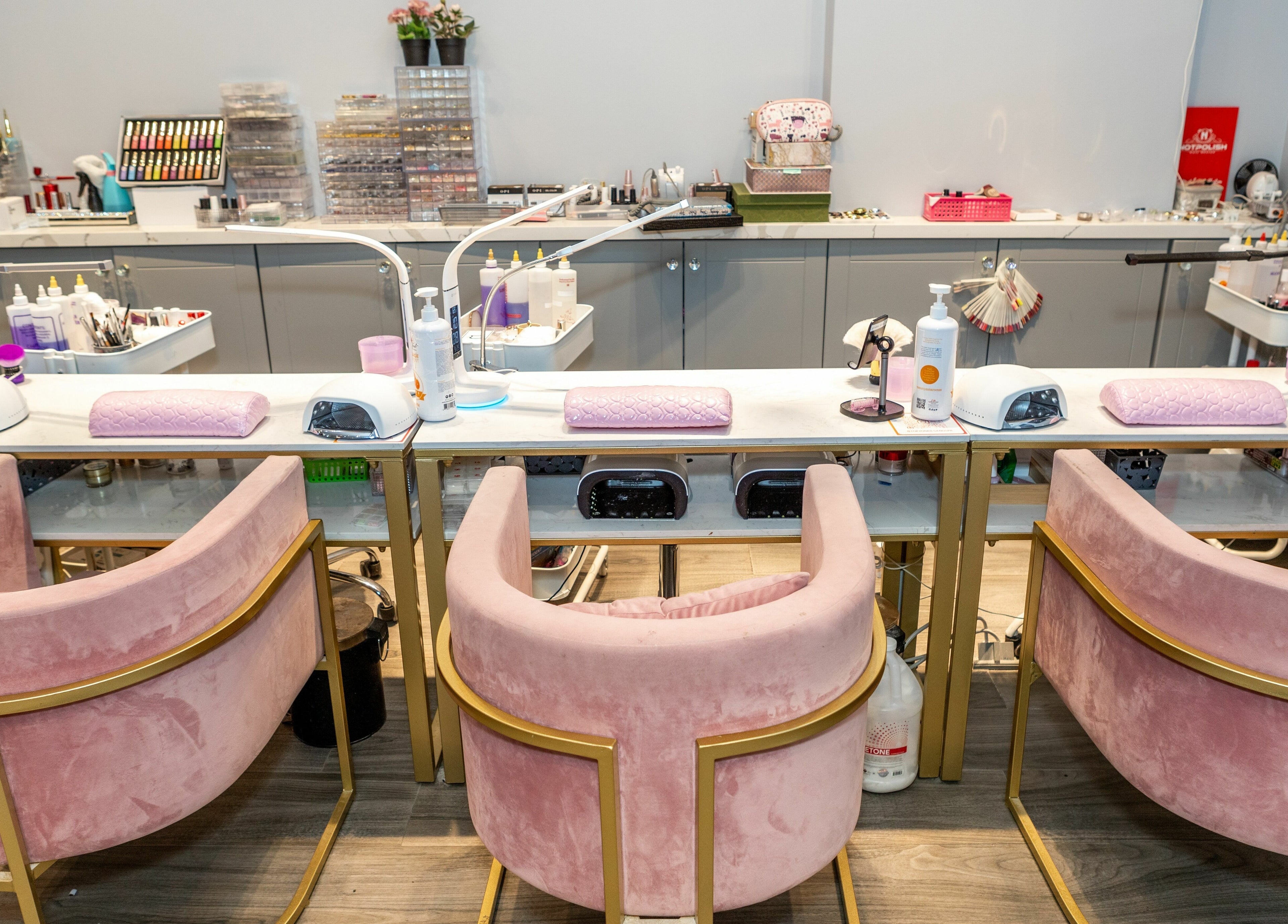 Elegant nail service station at Tokyo Nails and Spa in Toronto, Ontario, CA, featuring plush pink chairs and tools.