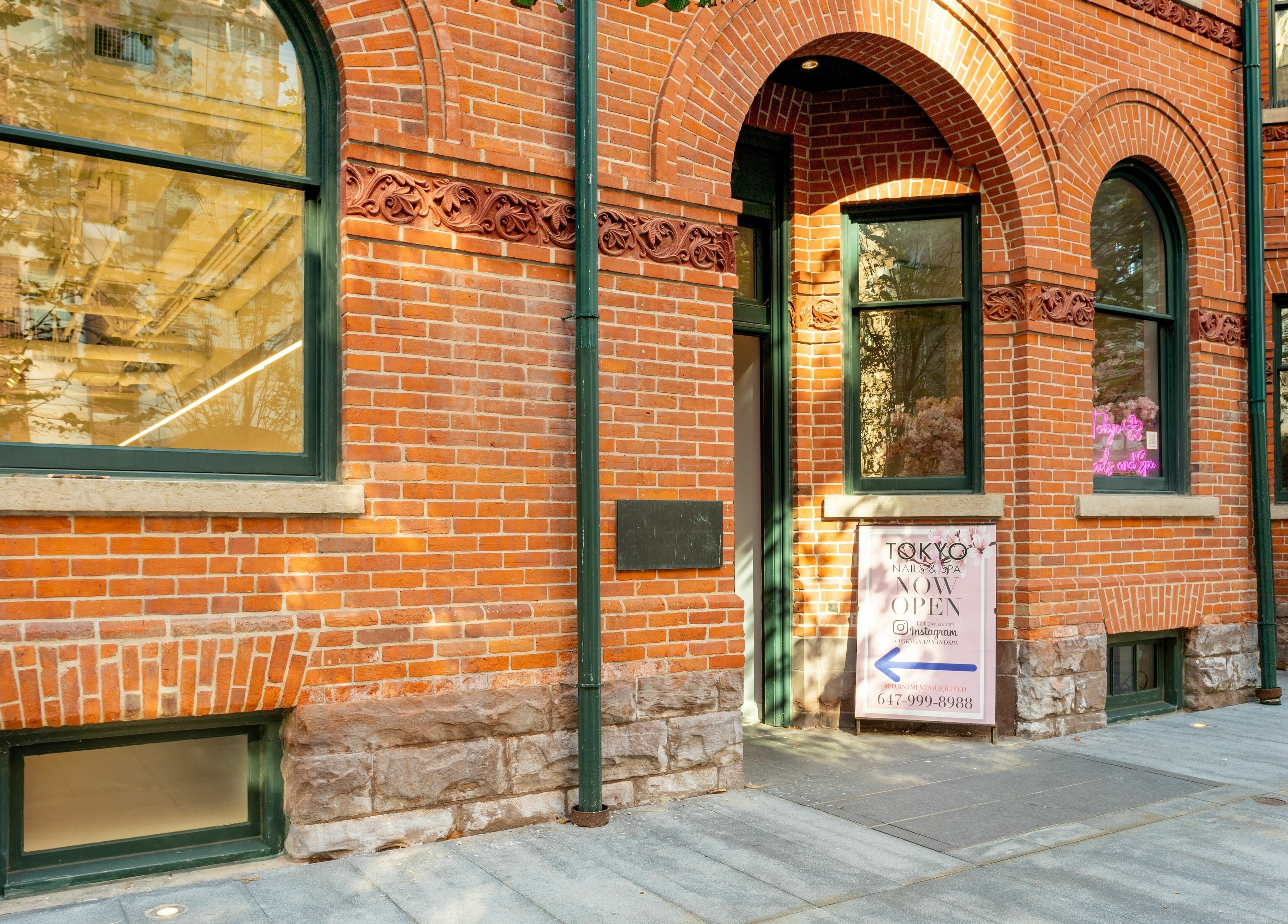 Entrance of Tokyo Nails and Spa in a charming brick building, located at Toronto, Ontario, CA.
