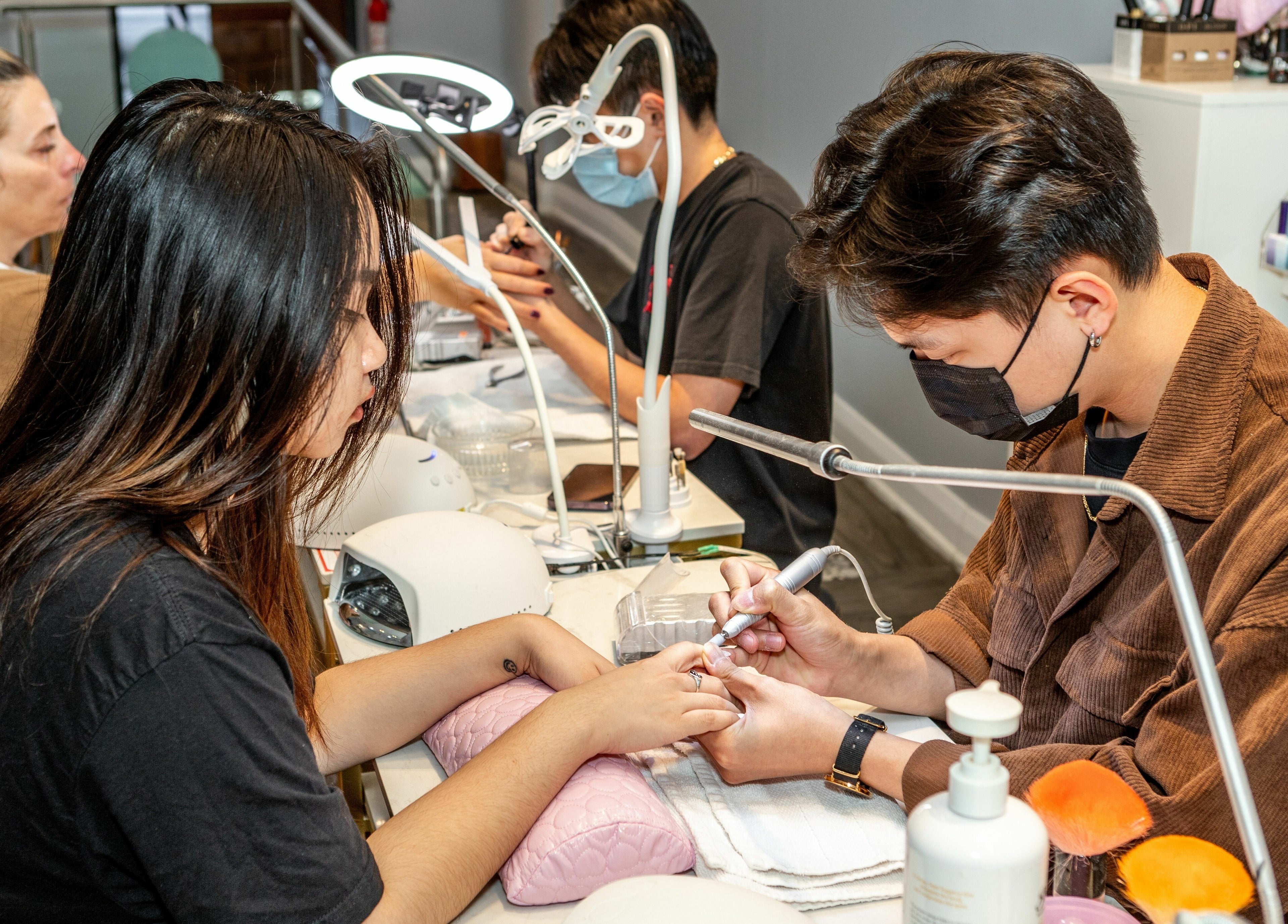 Nail technician at Tokyo Nails and Spa, Toronto, Ontario, CA providing manicure service.