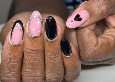 Nhanced in Bridgetown, Saint Thomas, BB features intricate black and pink nail art with heart and star designs.