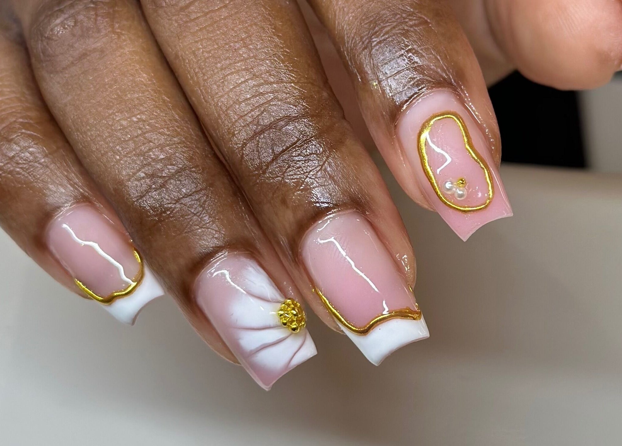 Elegant gold nail art at Nhanced, Bridgetown, Saint Thomas, BB showcasing intricate designs.