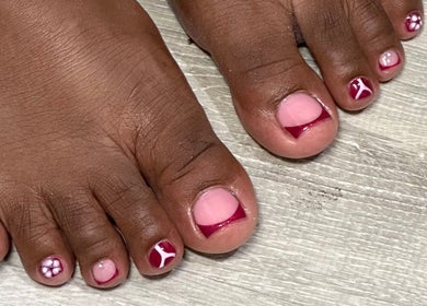 Stylish toenail art at Nhanced, Bridgetown, Saint Thomas, BB includes intricate red and pink designs.