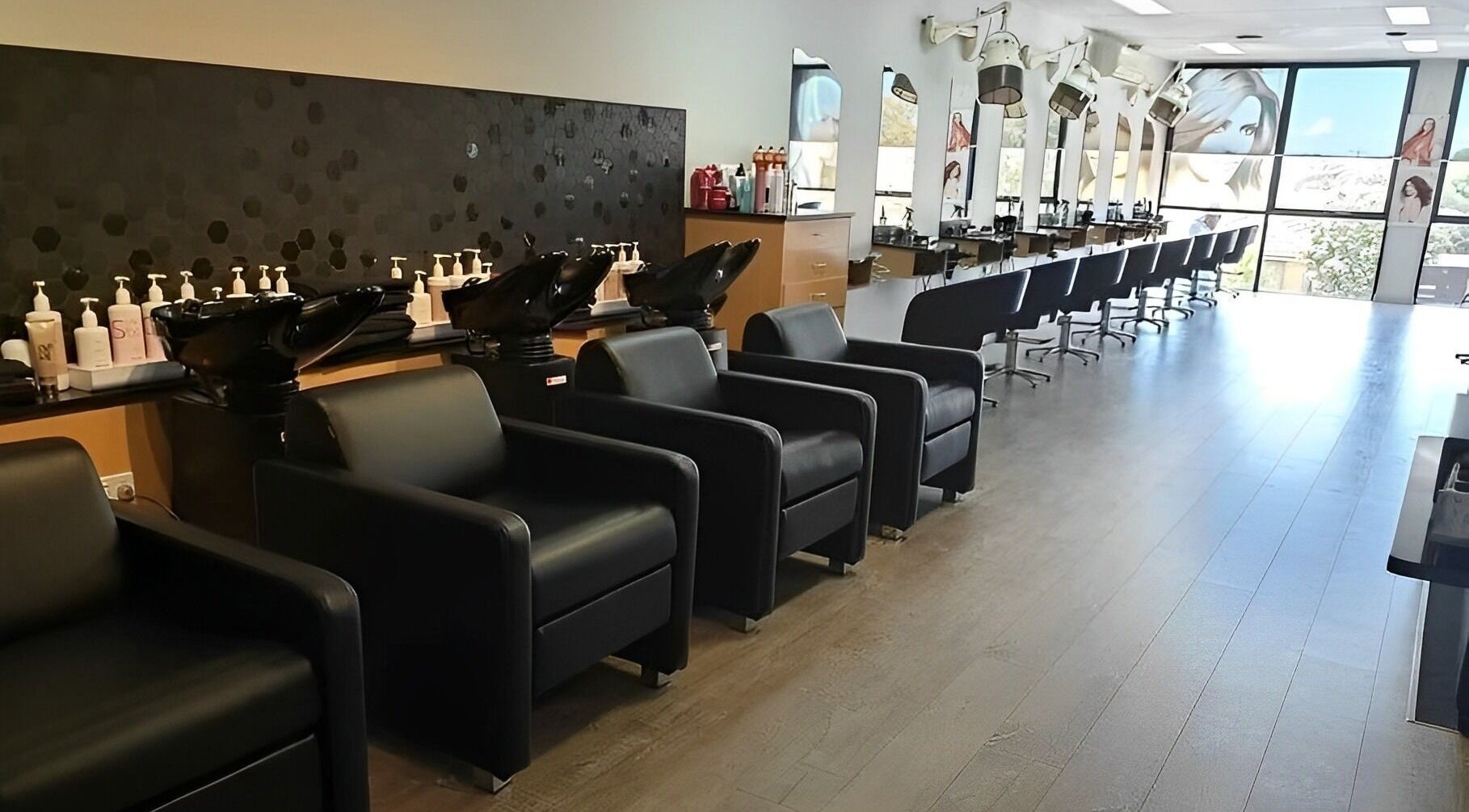 Modern hair salon interior at Marjon's Hair & Beauty Centre, Melbourne, Victoria, AU featuring styling chairs.