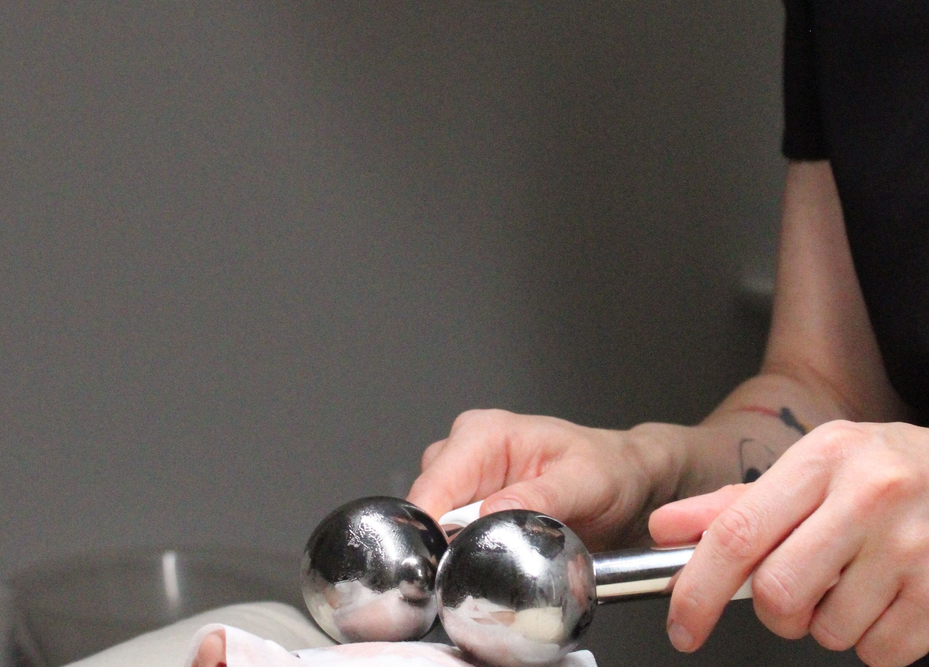 Therapist using metal massage tools at SILKMUSE Laser & Skin in Uddingston, Scotland, GB.