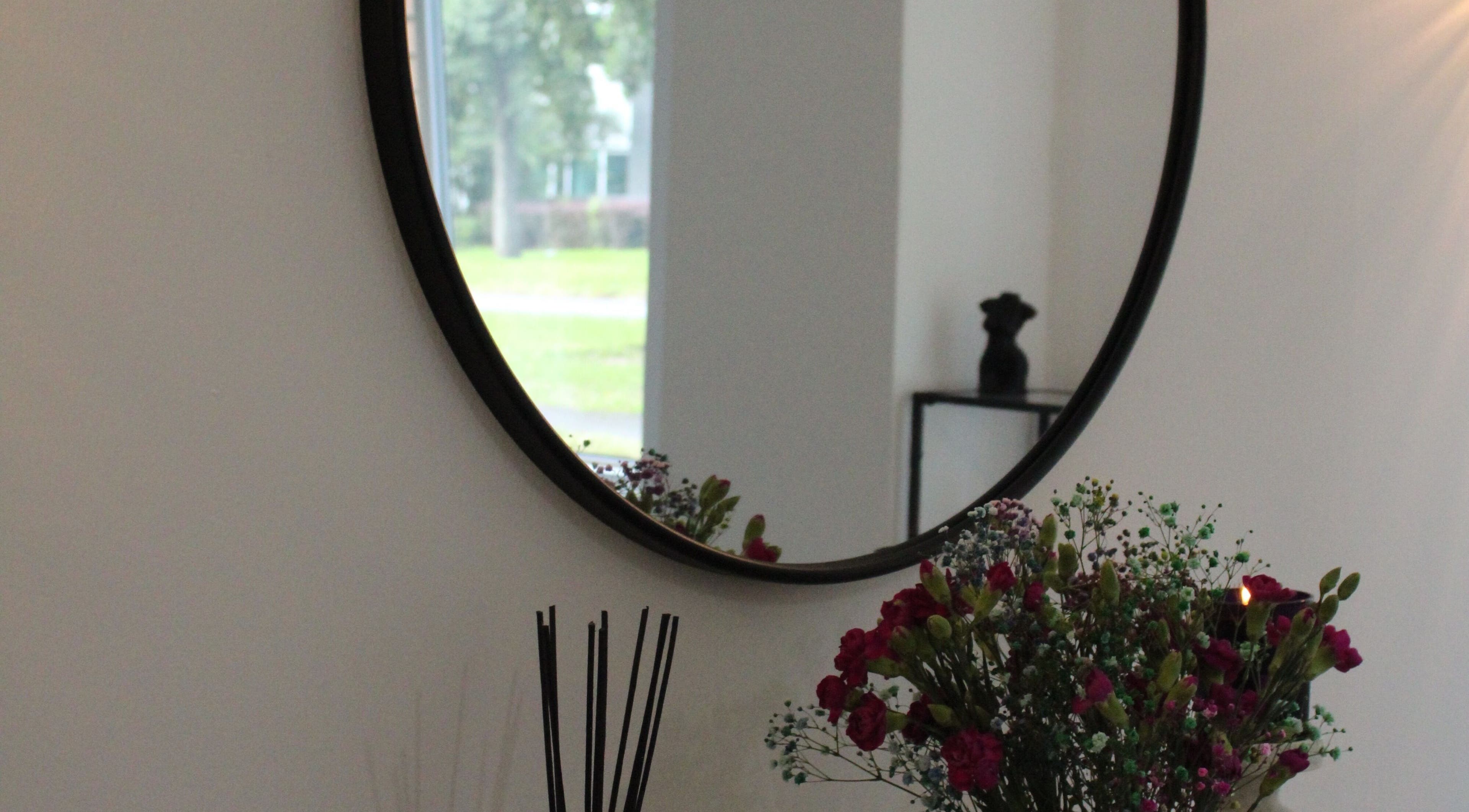 Elegant room decor at Silkmuse Laser & Skin, Uddingston, Scotland, GB featuring a mirror and flowers.