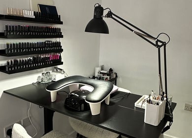 Modern nail station at Pixy Beauty in Stafford, England, GB, featuring sleek decor and organized nail polish display.