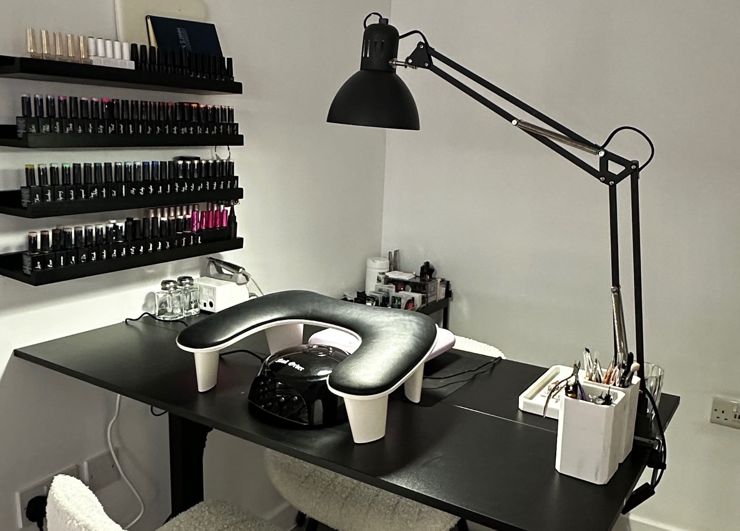 Modern nail station at Pixy Beauty in Stafford, England, GB, featuring sleek decor and organized nail polish display.