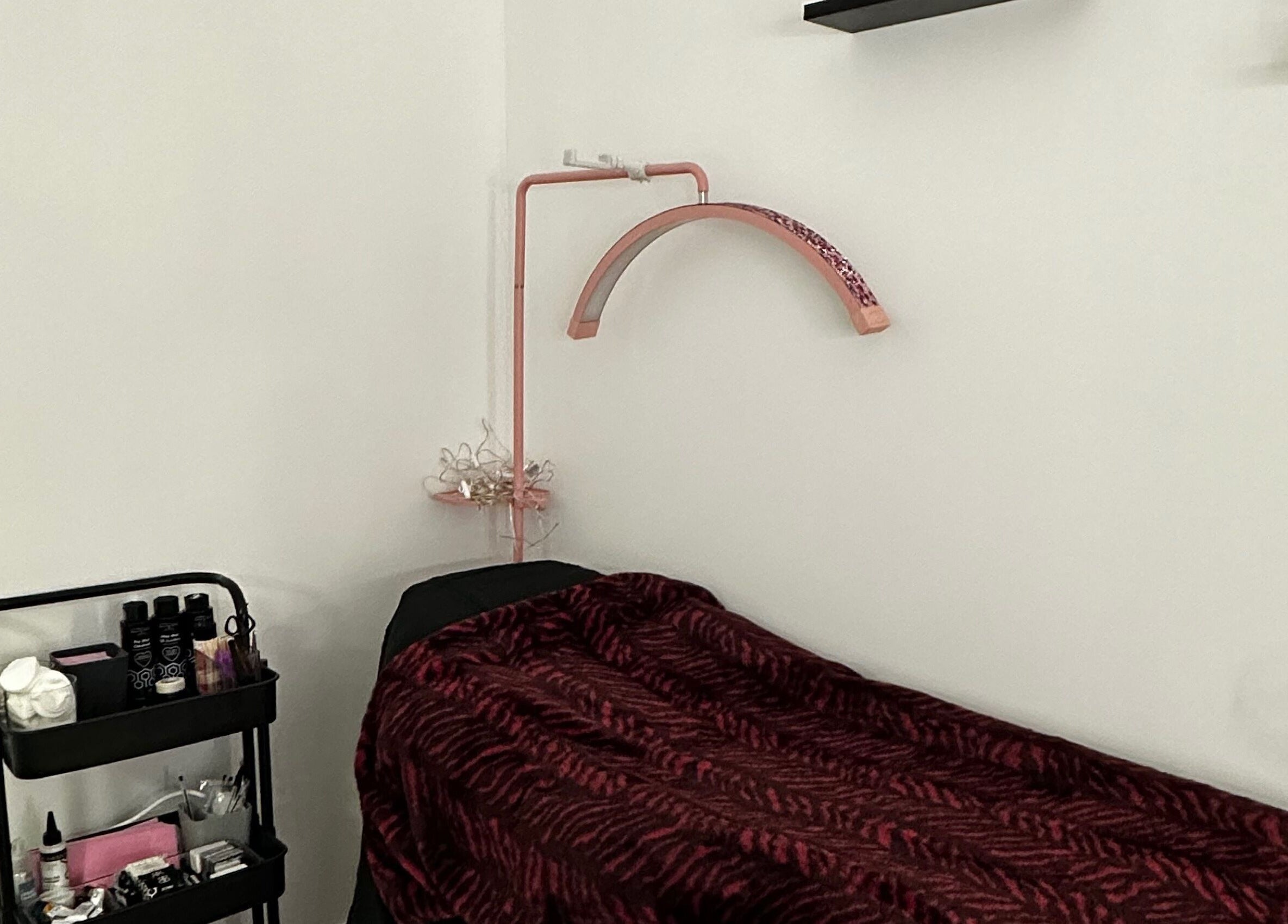 Comfortable treatment bed at Pixy Beauty, Stafford, England, GB, awaits clients for premium spa services.