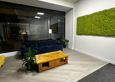 Sophisticated lounge at Pixy Beauty, Stafford, England, with plush seating and green decor.