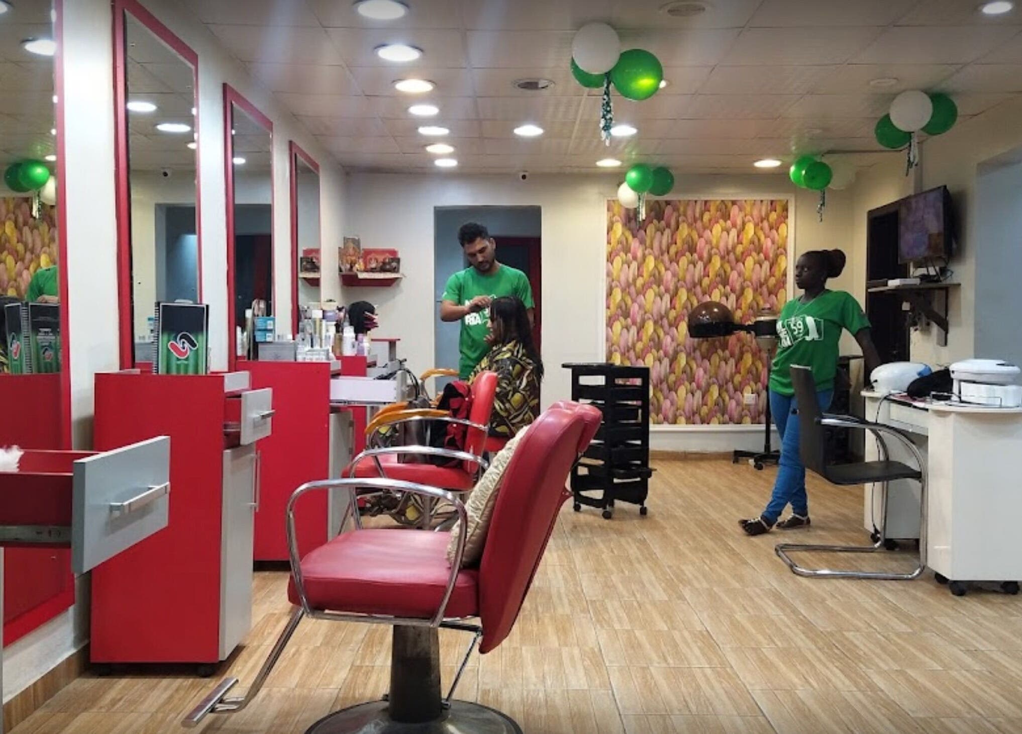 Studio Strands salon in Lagos, NG, featuring chic red styling chairs and professional hair services.